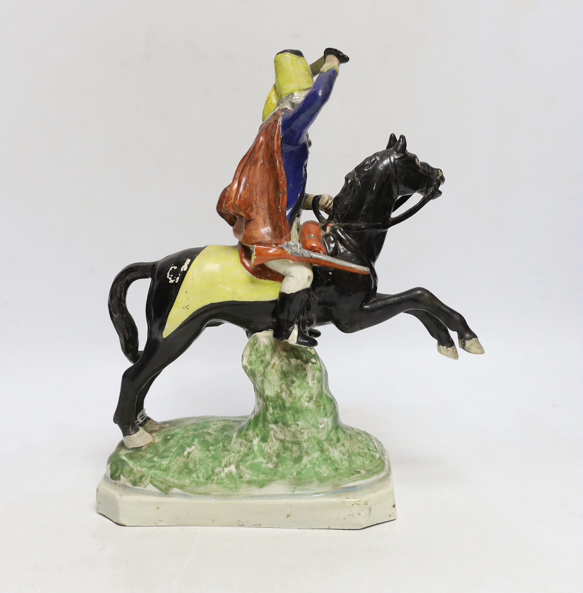 A Staffordshire pearlware group of a Hussar on a leaping horse, c.1820, restored, 27cm high